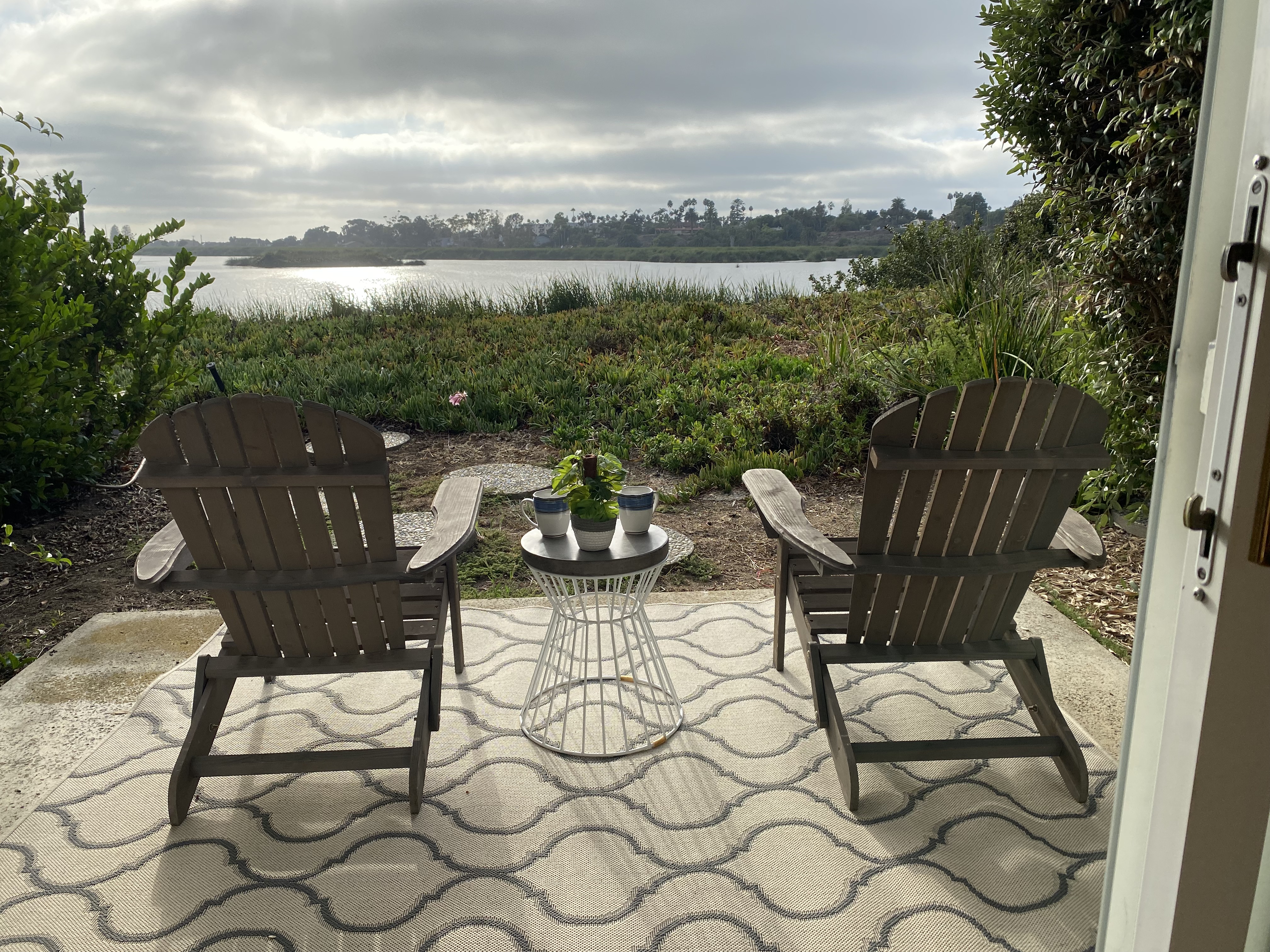 A view of the irvine marsh with two lawn chairs during a foggy day